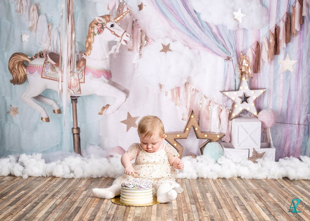 First birthday celebration setup with carousel theme and soft cotton cloud decorations.