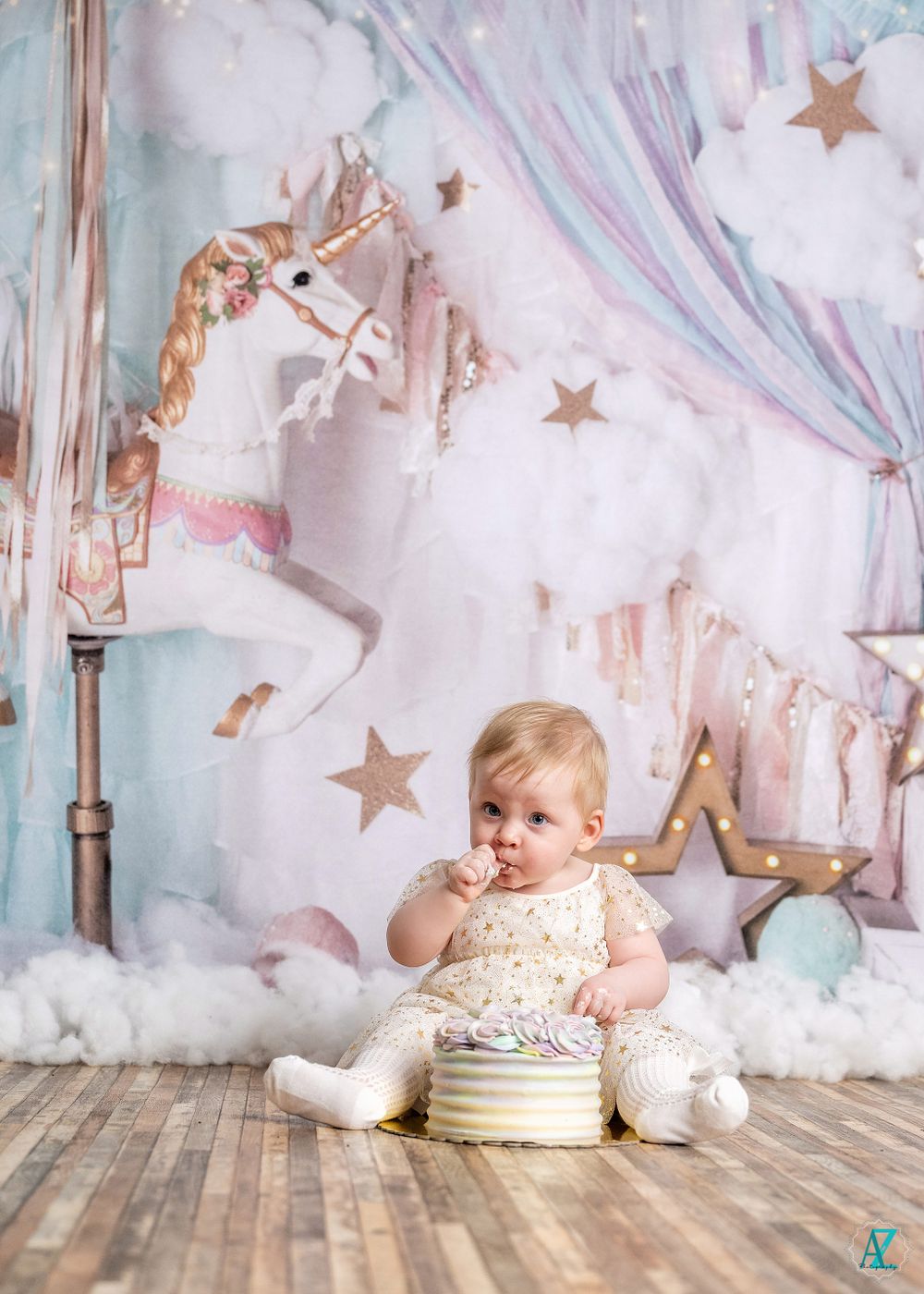 Dreamy first birthday photo scene with carousel horse and star decorations.