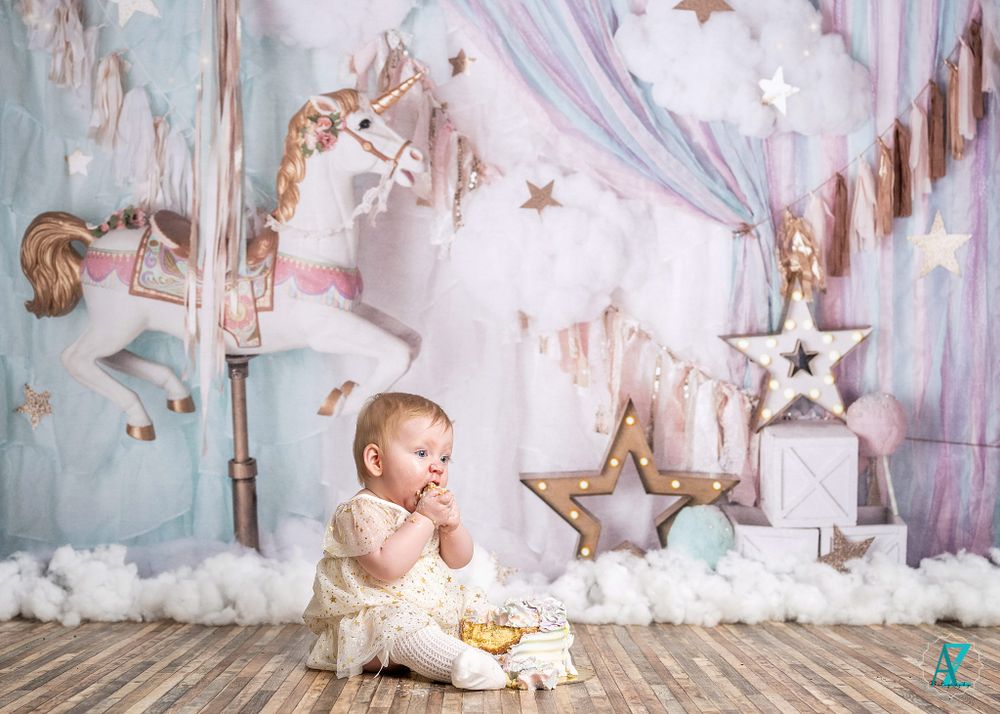Small child in lace outfit explores magical setup with stars and carousel decorations.