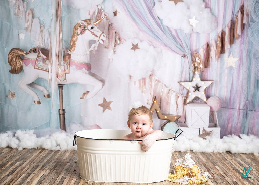 Adorable bath scene with white tub against dreamy star and carousel wall backdrop.