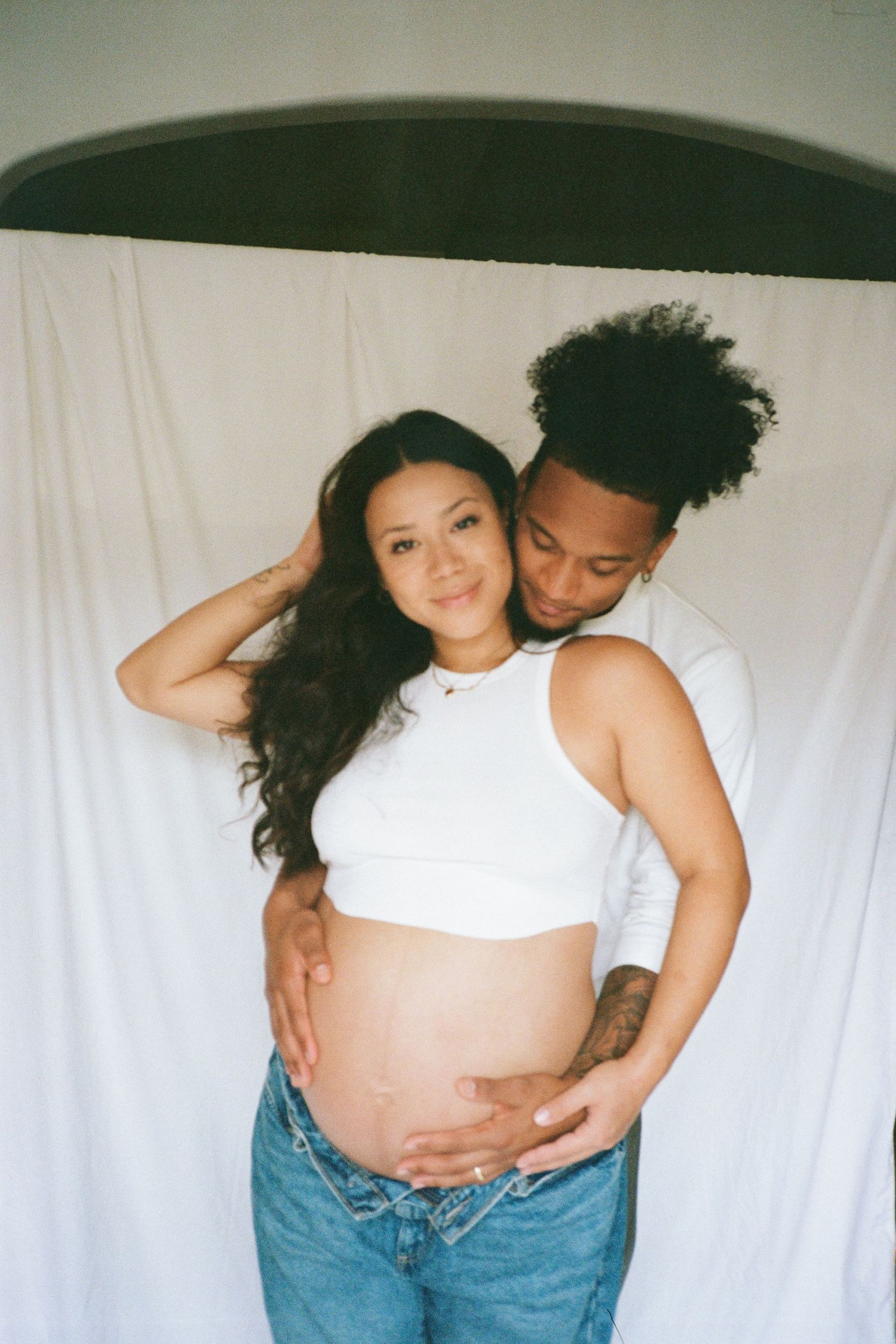 Natural maternity photography showing intimate moments between expectant parents.
