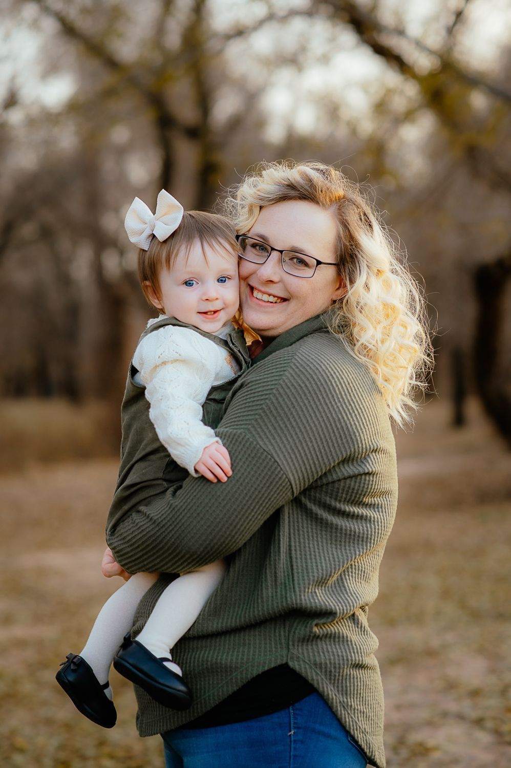 Mom and toddler smile for family photos with Taryn Elizabeth one of the photographers in Enid OK.