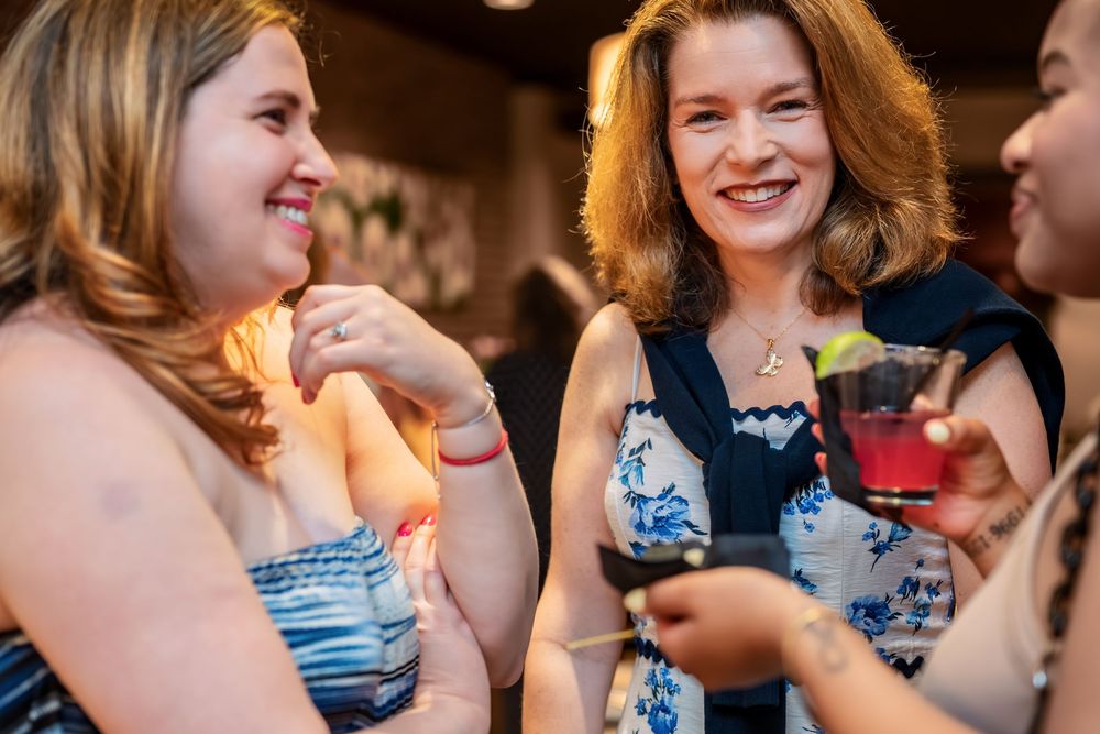 Festive gathering with people dancing and celebrating in colorful dresses.