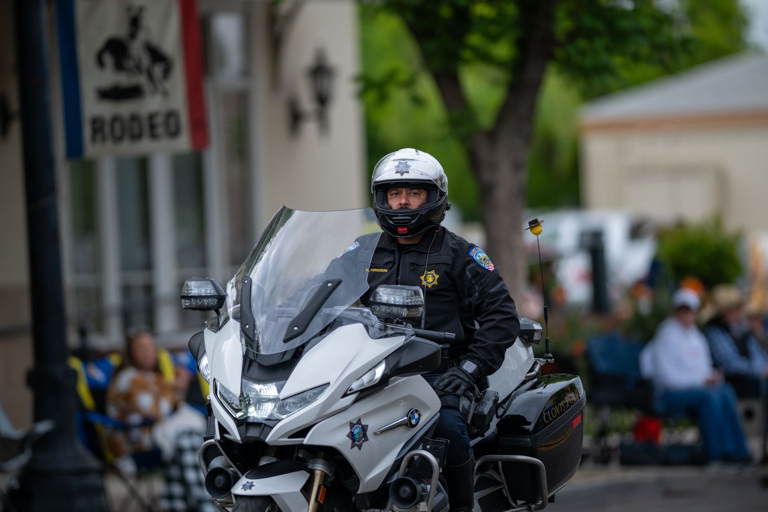Police officers on motorcycles patrolling during a community event.