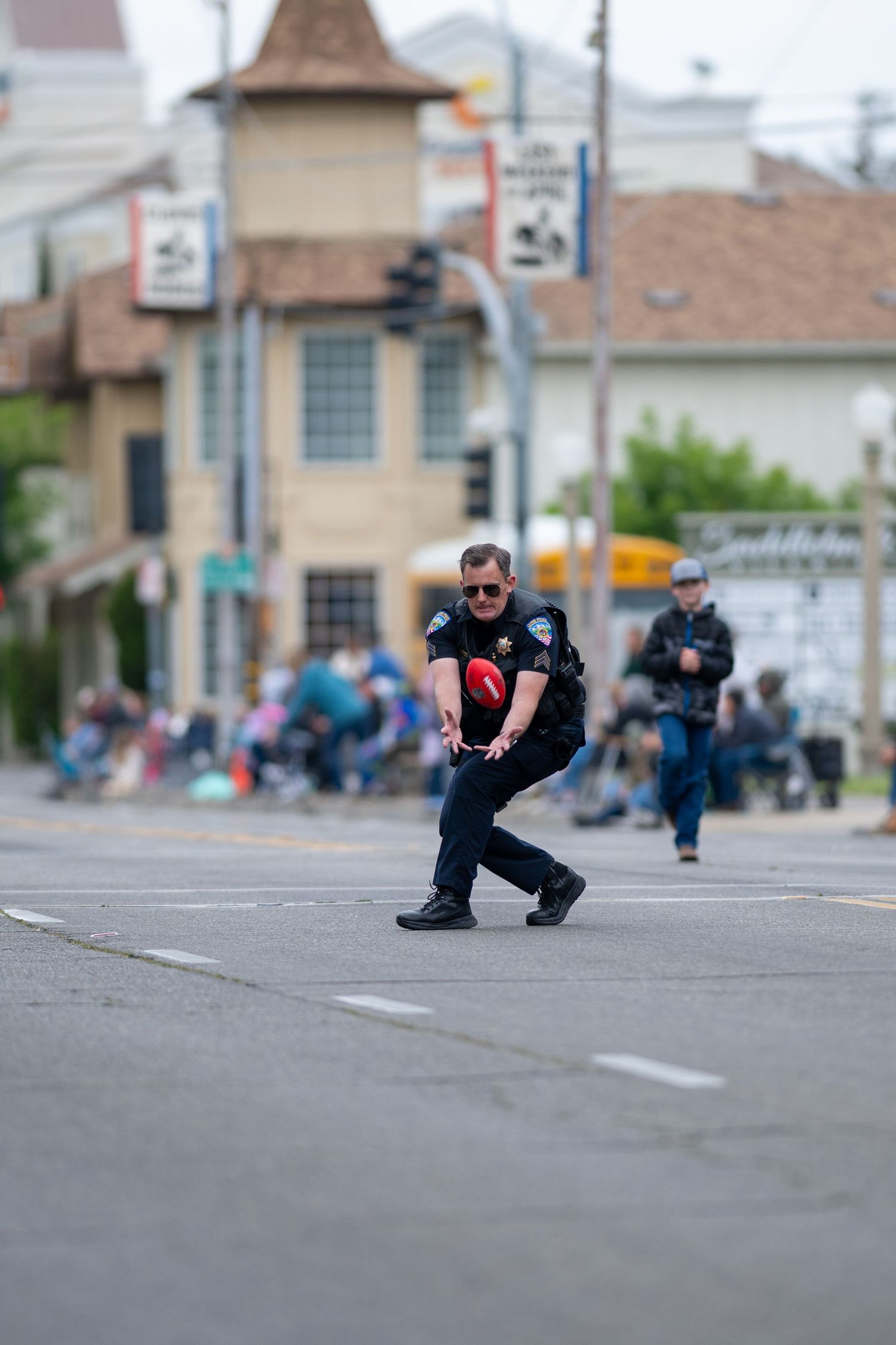 Police officers in tactical positions taking cover on a city street.
