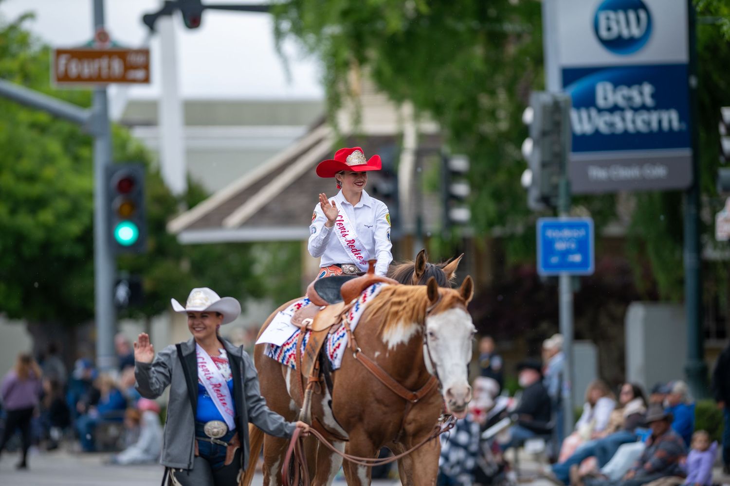 Downtown street view showing Best Western hotel sign and parade participants.