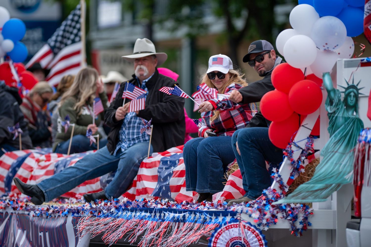 Patriotic parade decorations with red white and blue banners and American flags along the street.