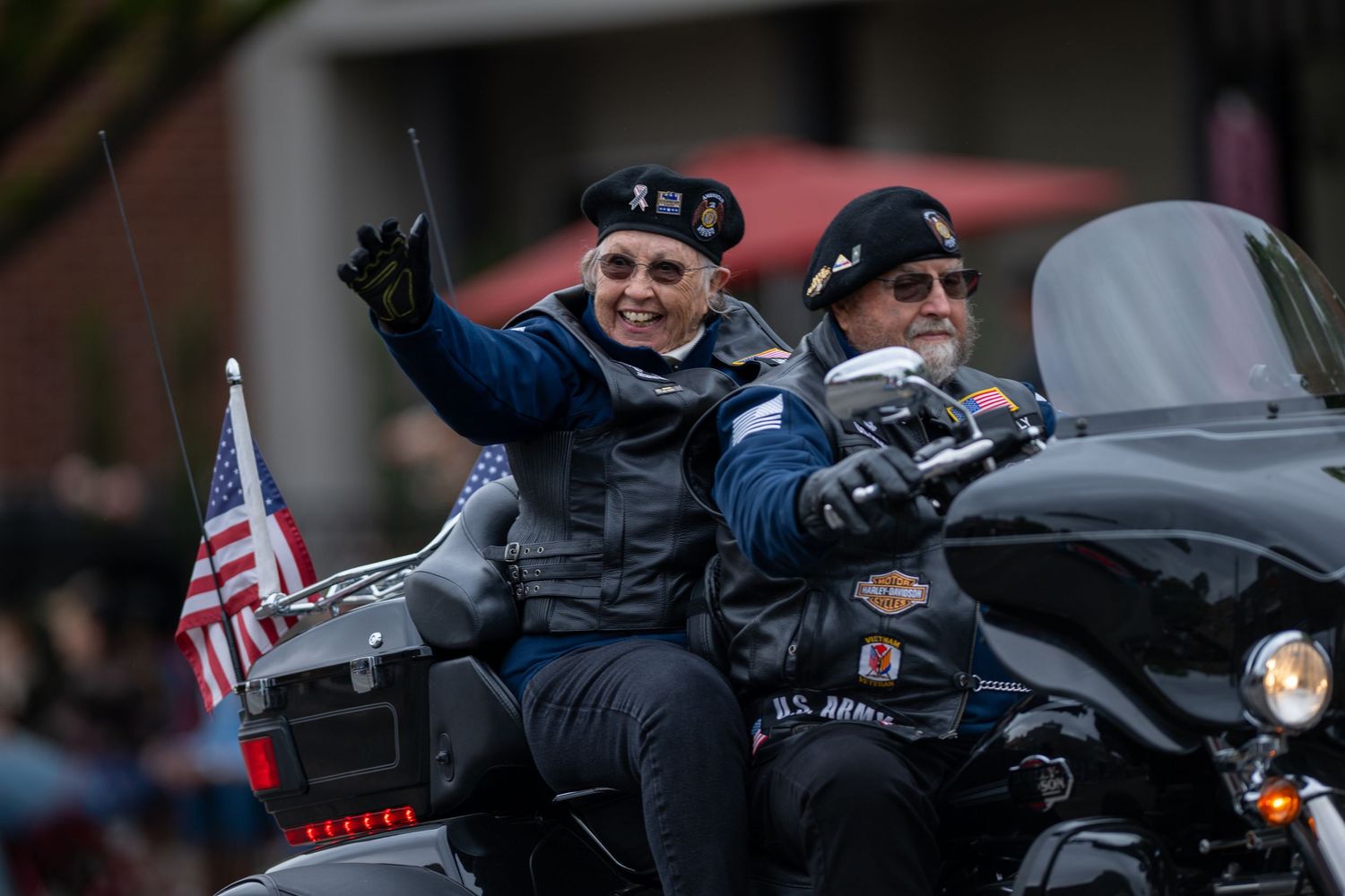 Motorcyclists riding in formation during a patriotic community parade event.
