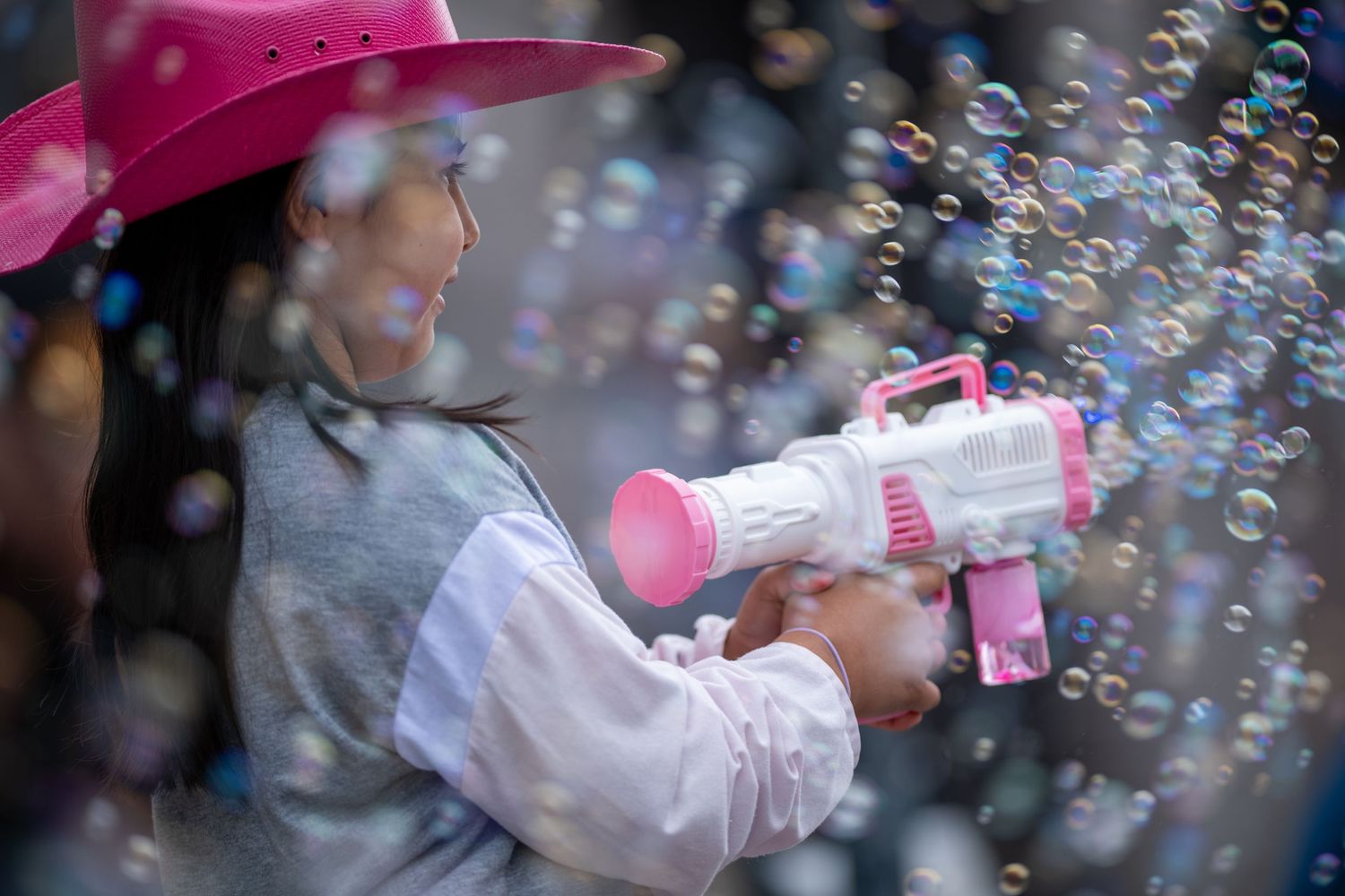 A bubble blowing toy gun creating a magical display of soap bubbles in the air.