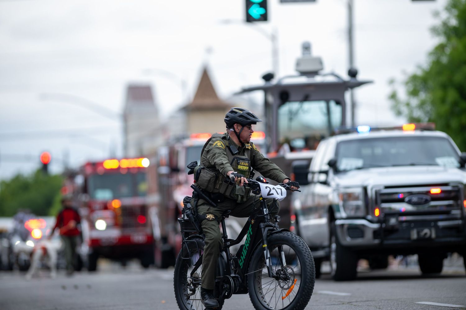 Law enforcement officer patrolling on a bicycle during a community event.