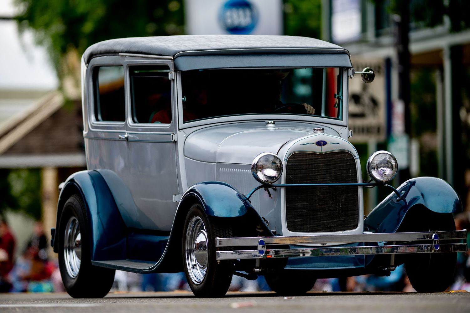 A classic gray Ford Model A hot rod parked on display.