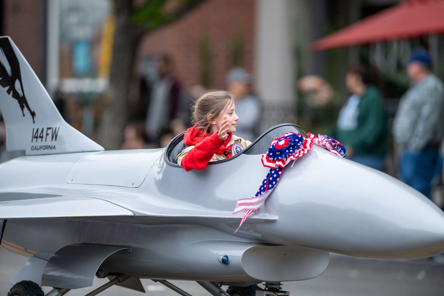 A model fighter jet display with patriotic decorations.