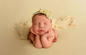 Newborn photography series showing six peaceful sleeping poses with soft white and cream backgrounds.