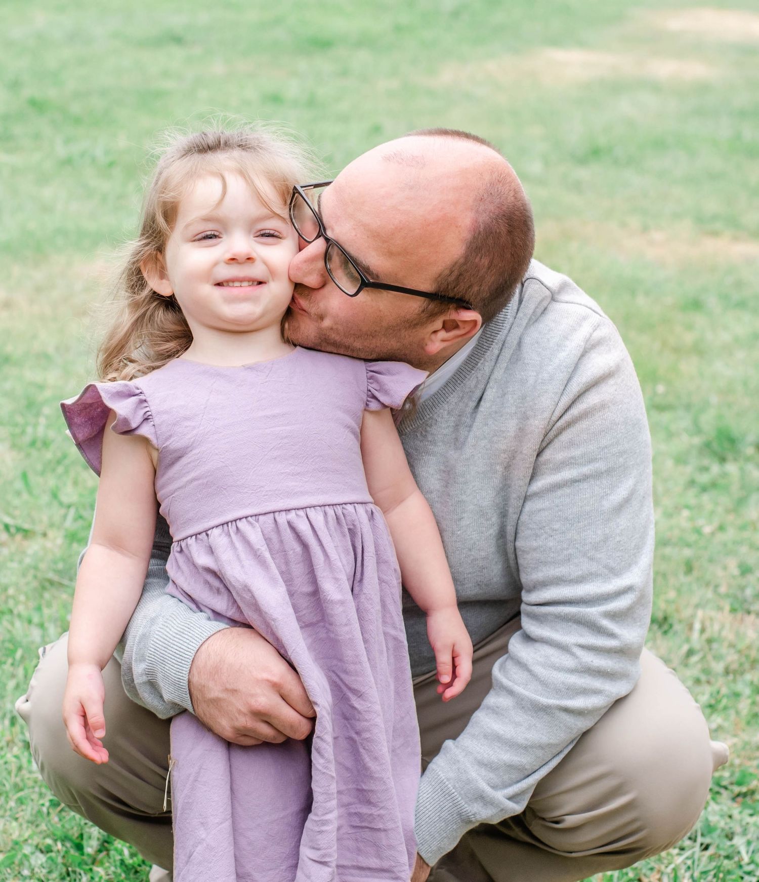 Sweet outdoor photo session in green grass with purple dress.