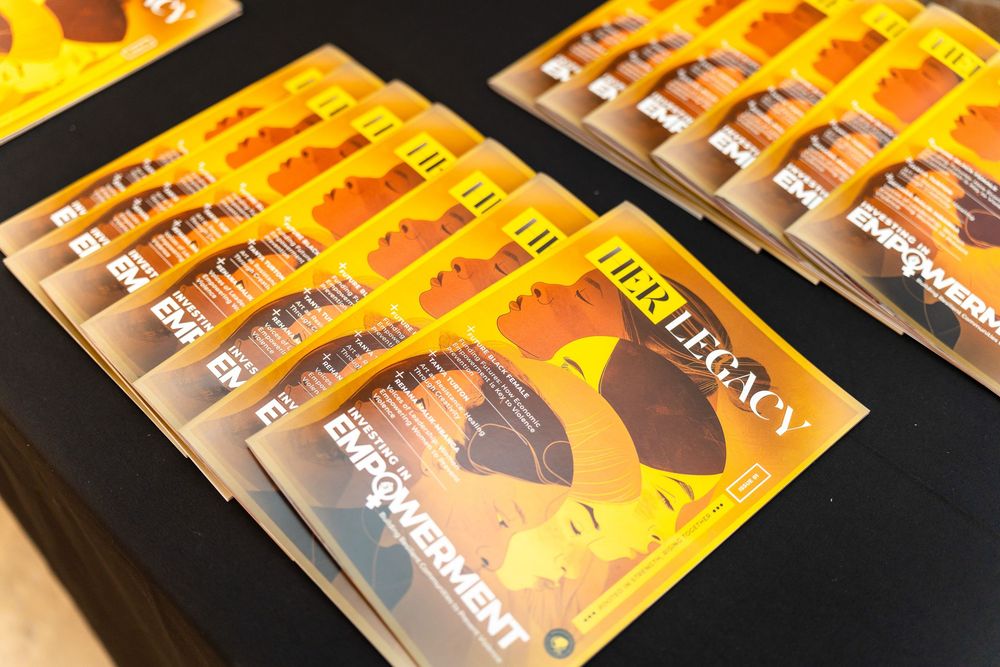 Stacks of bright yellow and brown paperback books arranged diagonally on a dark surface.