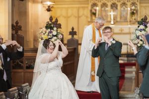 Joyful celebration during wedding ceremony in historic church with ornate decorations.