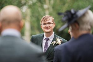 A wedding ceremony moment outdoors with guests in attendance.
