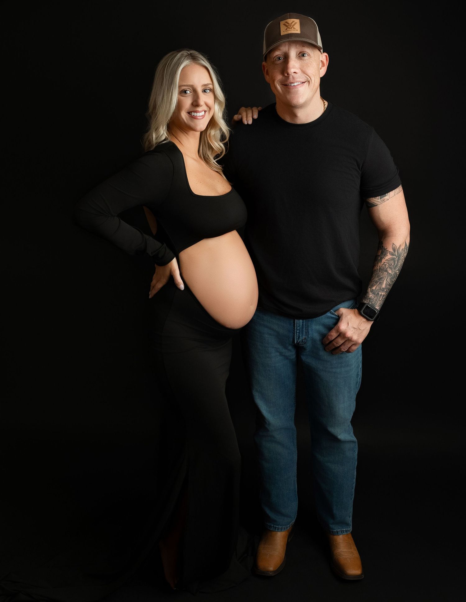 Mom and Dad is looking at the camera smiling for their maternity session. Greenville, SC newborn photographer, Easley SC newborn photographe