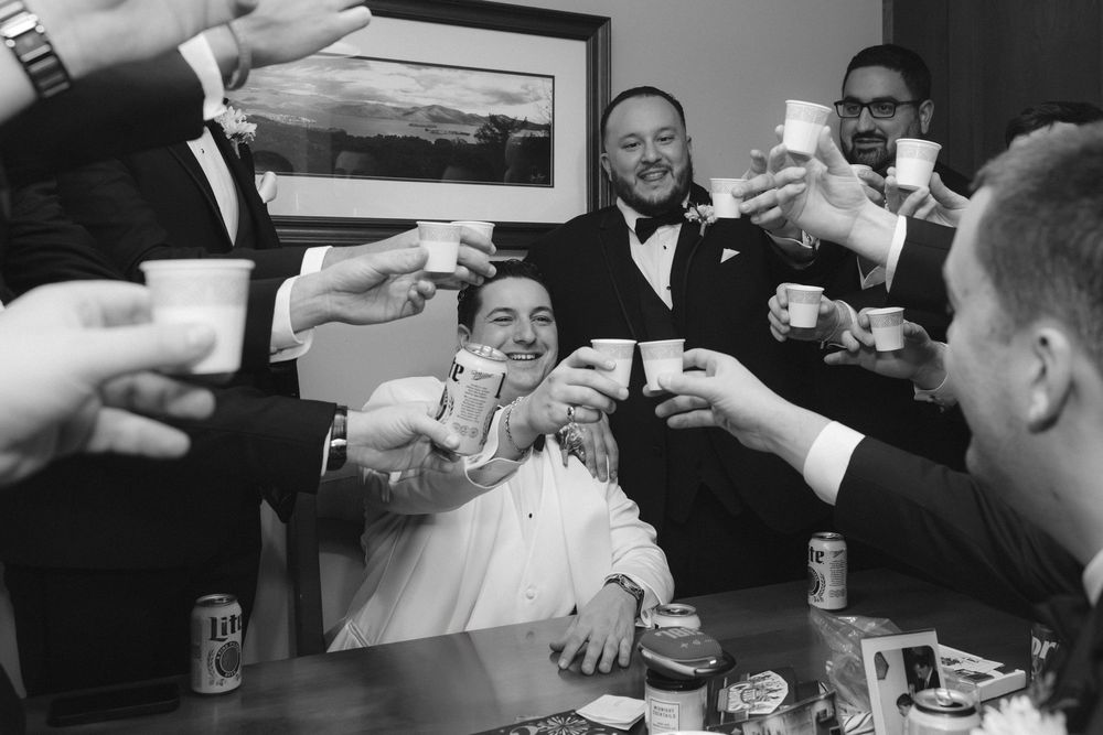 Black and white photo sequence shows people playing a drinking game at a social gathering.