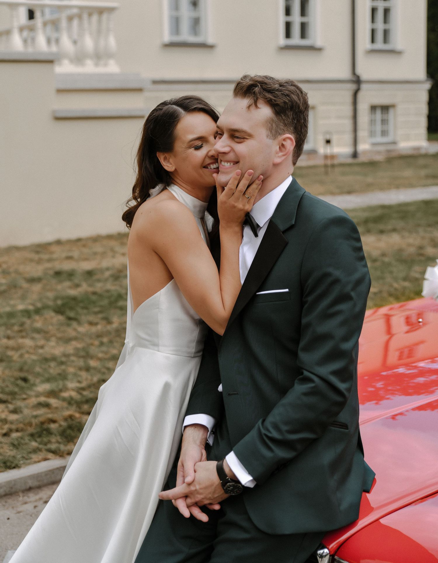 Romantic moment between couple against classic building backdrop.