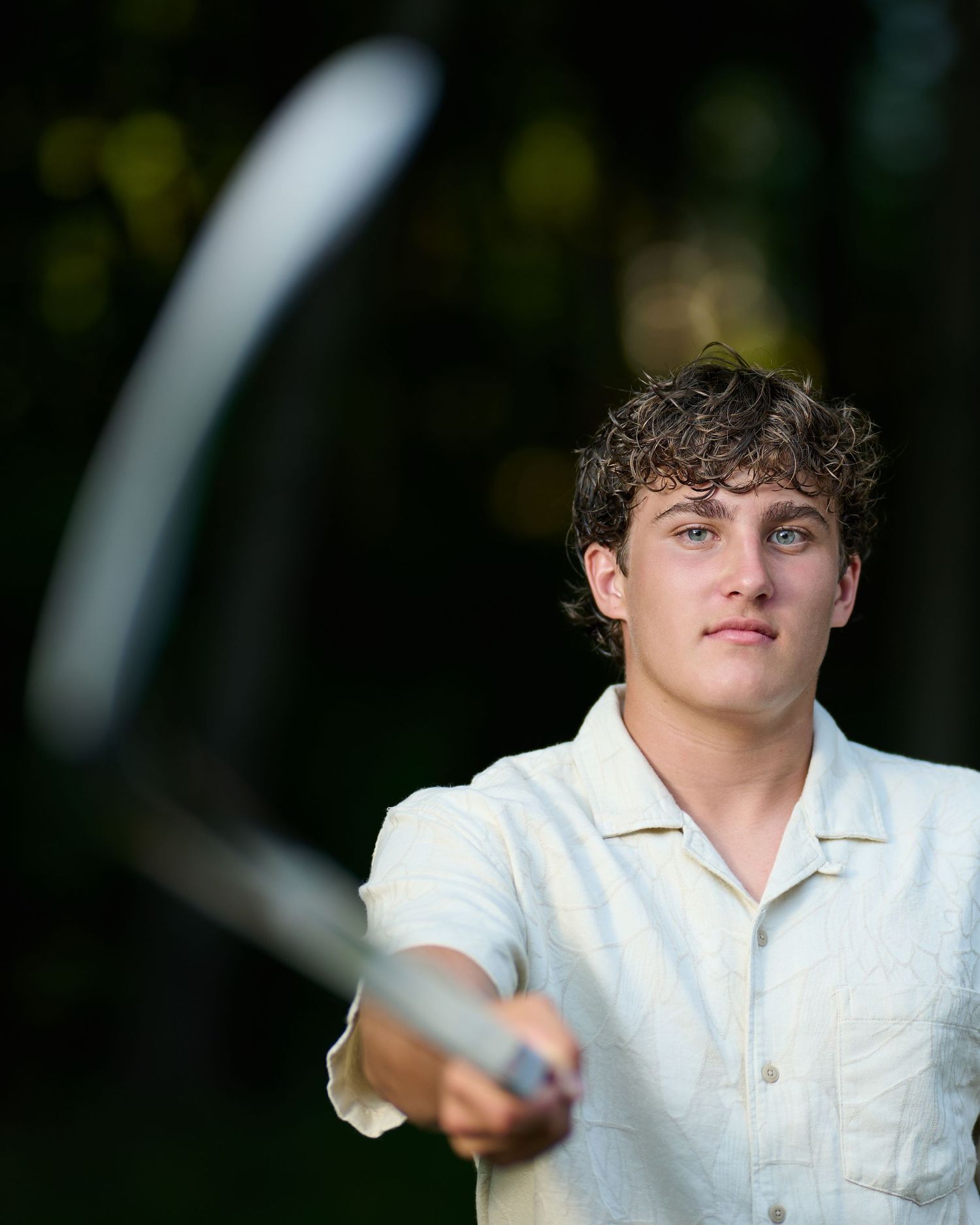 A series of outdoor portrait photos featuring someone wearing a white collared shirt against a blurred background.