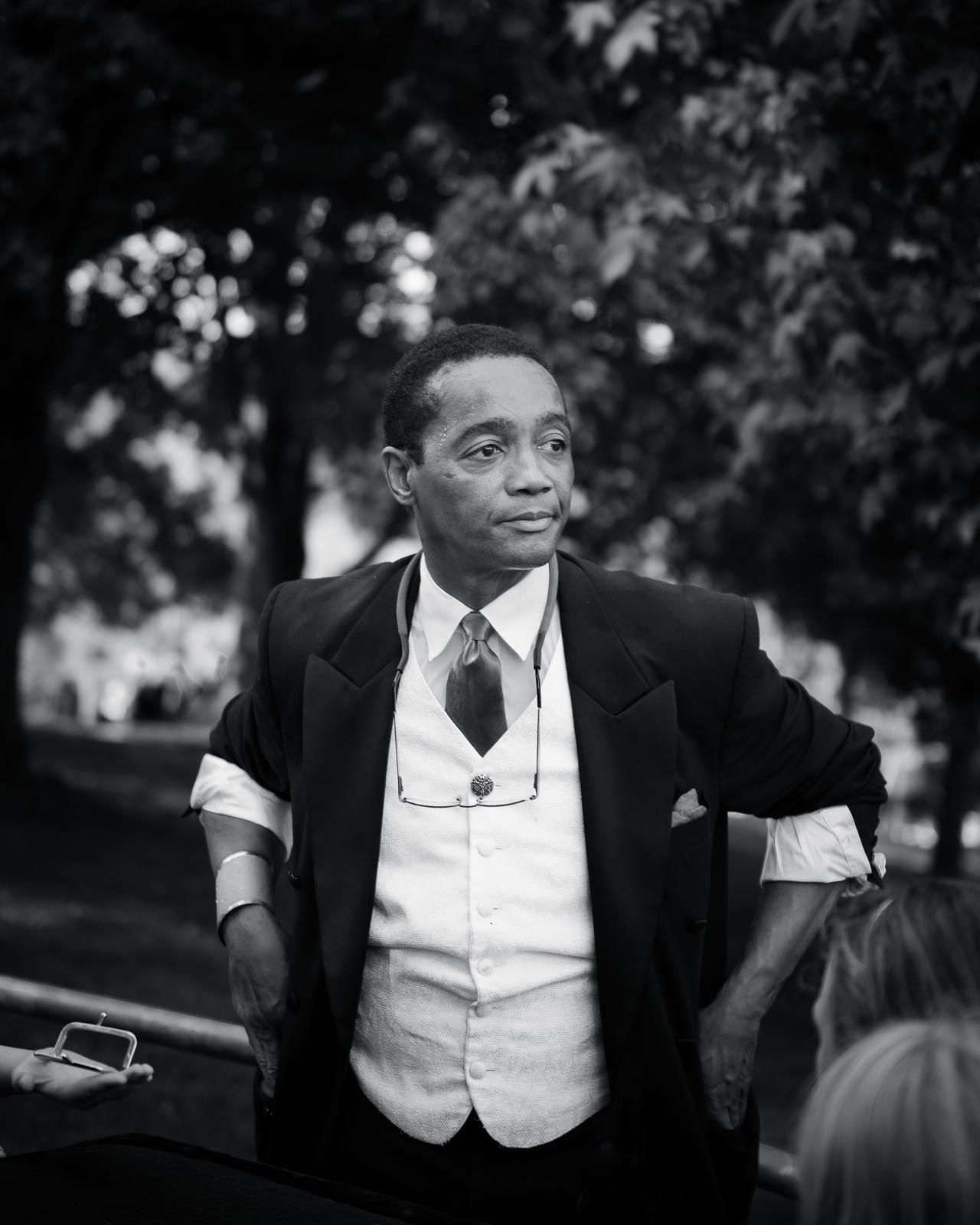 Vintage black and white photo showing a man in formal attire with vest and suit jacket.