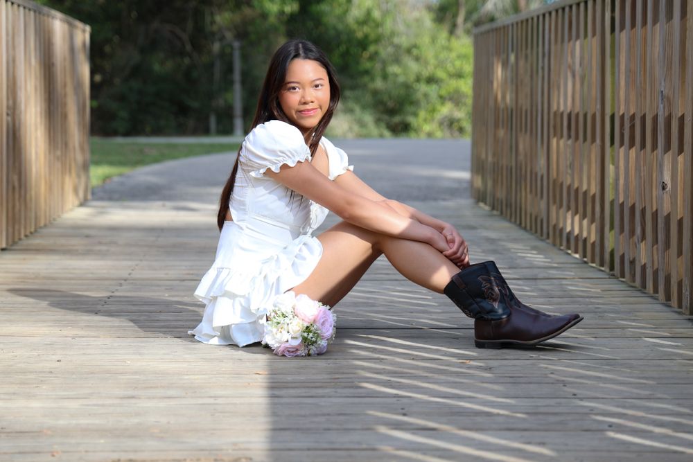 Portrait series on a wooden boardwalk surrounded by natural scenery.