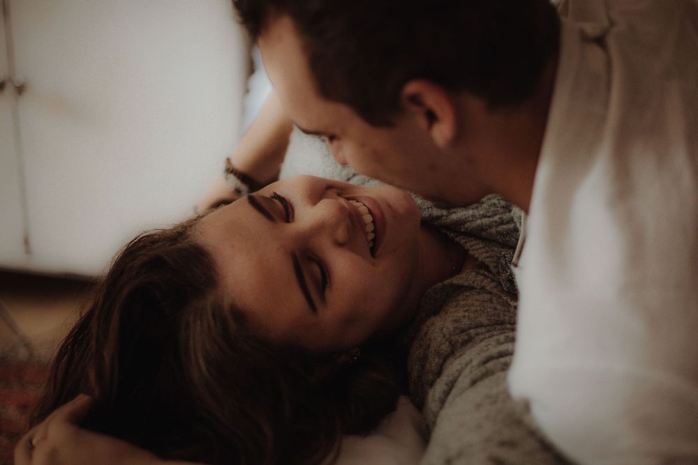 Close-up romantic moment captured between couple lying down together.