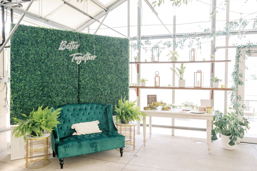 Modern greenhouse venue with white walls and green accents creating a bright, airy space.