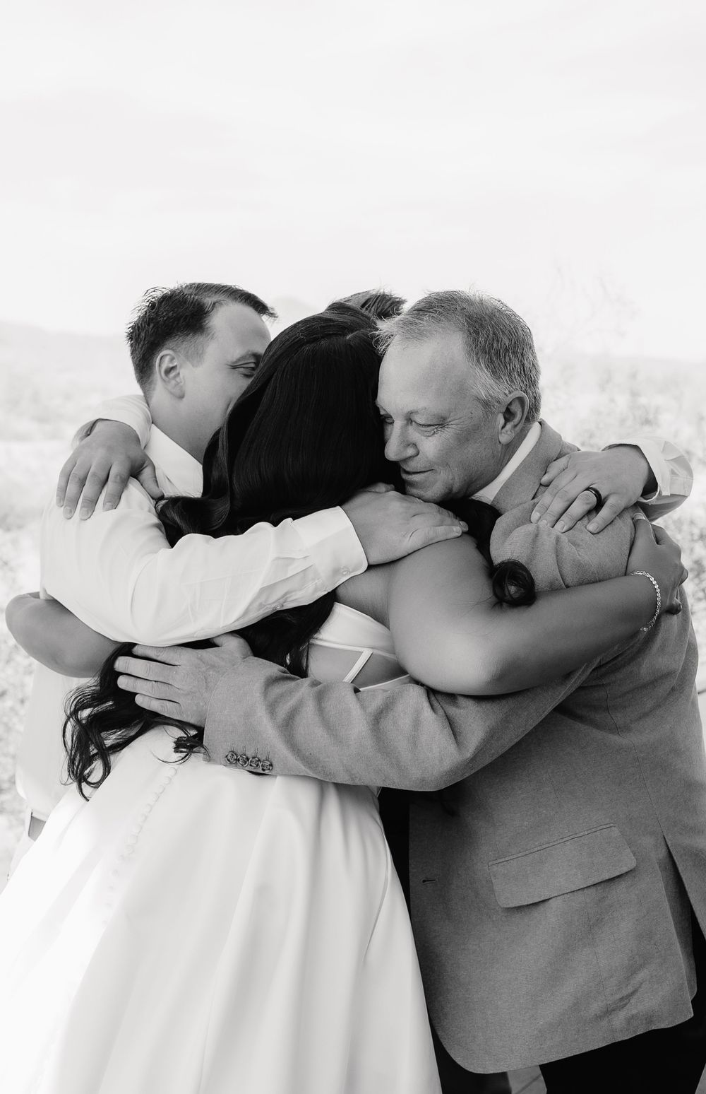 A series of emotional embraces captured in black and white during a wedding ceremony.