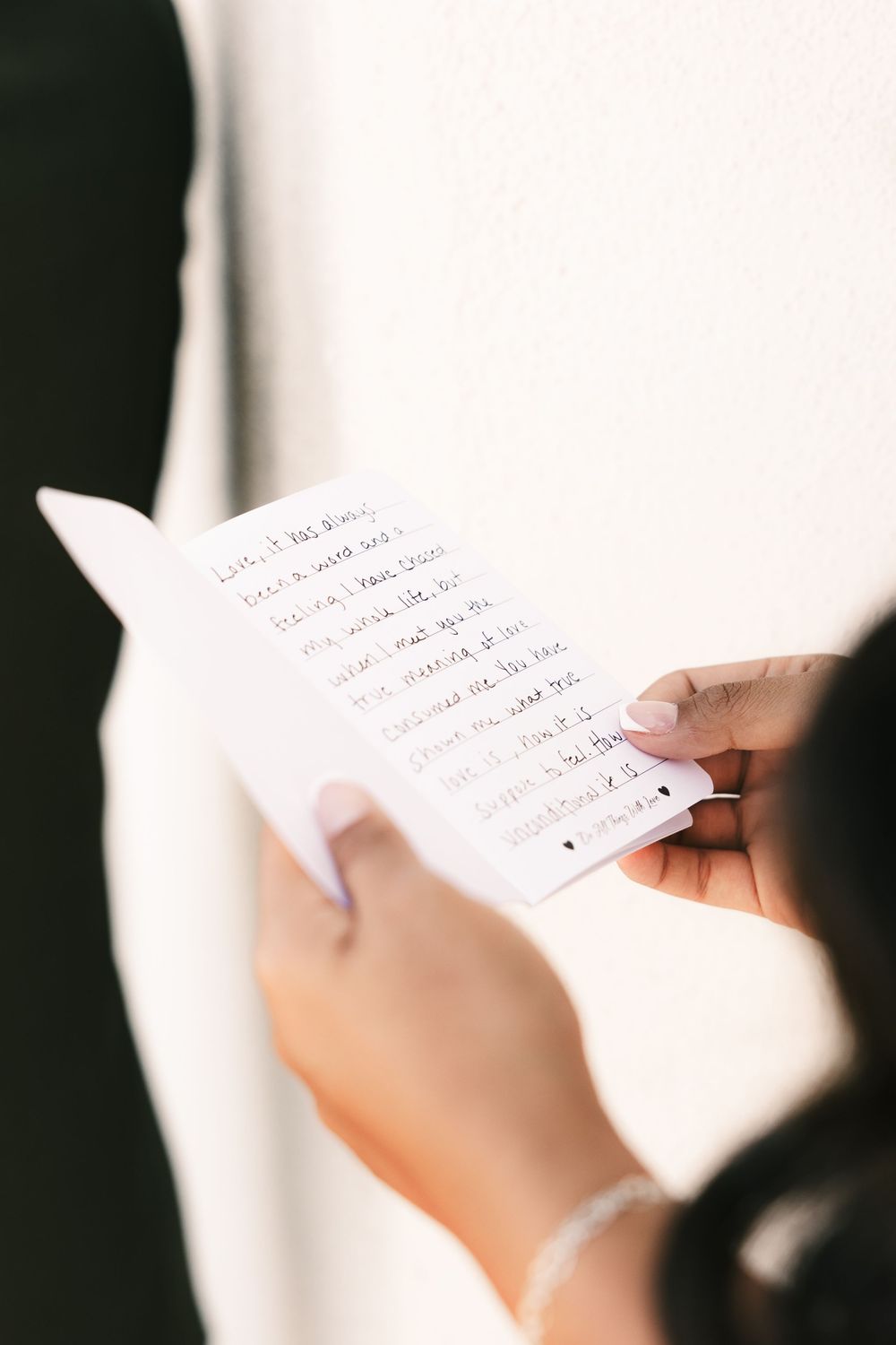 Close-up shots of handwritten wedding vows being read during the ceremony.