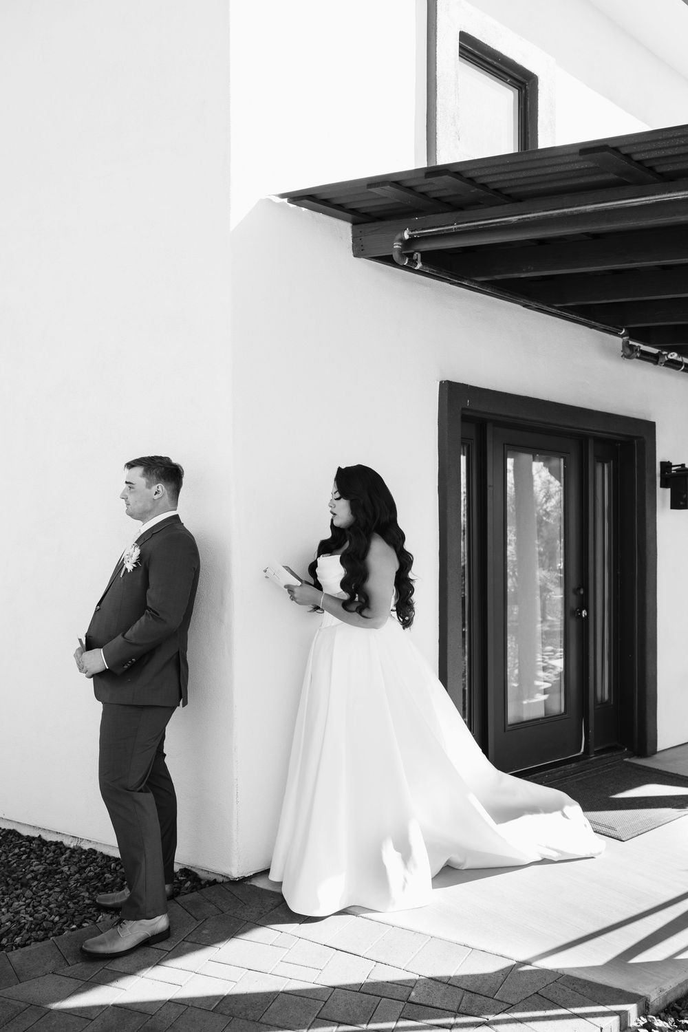 Creative wedding photo sequence showing couple playing peek-a-boo around white wall corners in black and white.