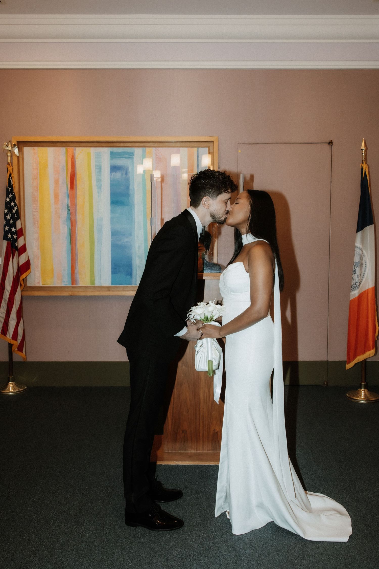 Intimate moment shared during a civil wedding ceremony with American and Irish flags displayed.