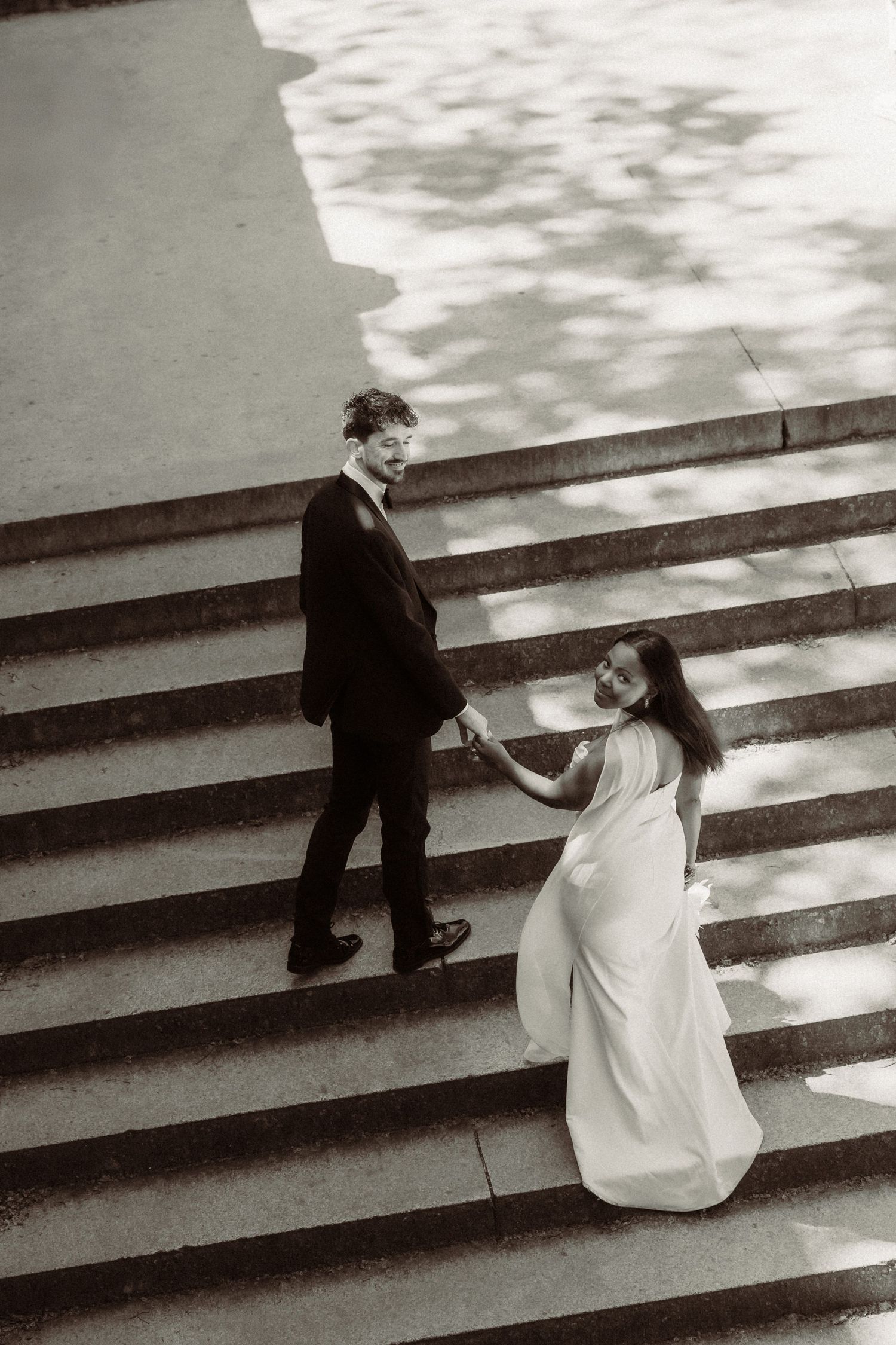 Black and white sequence showing a couple sitting on concrete steps outdoors.