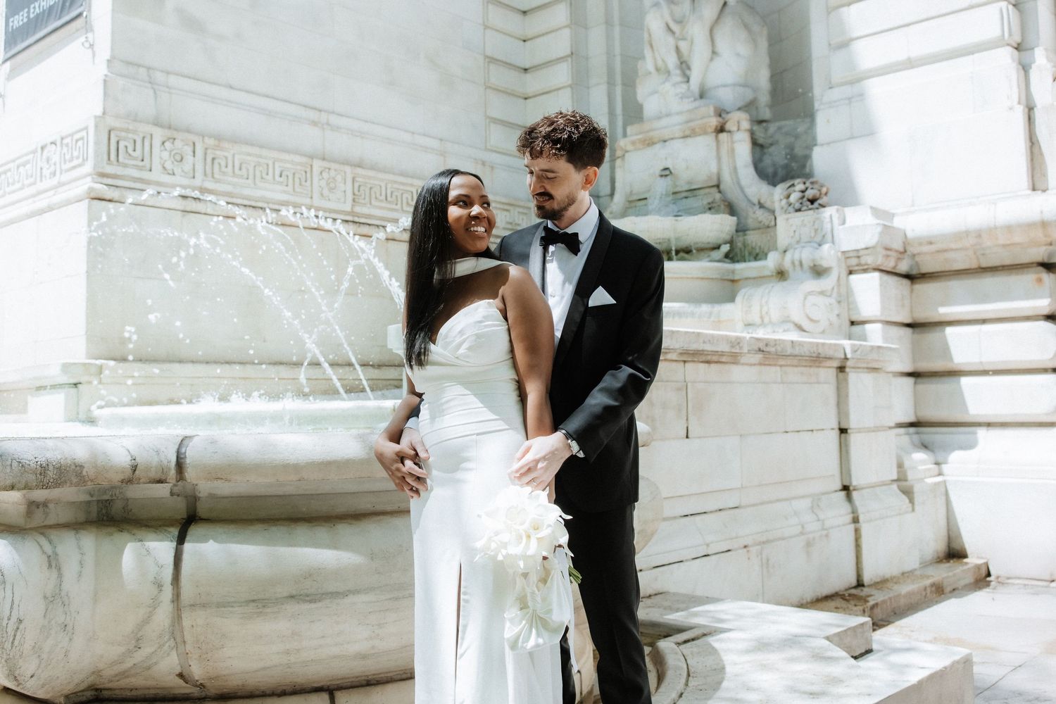 Romantic sequence against classic white stone architecture and columns.