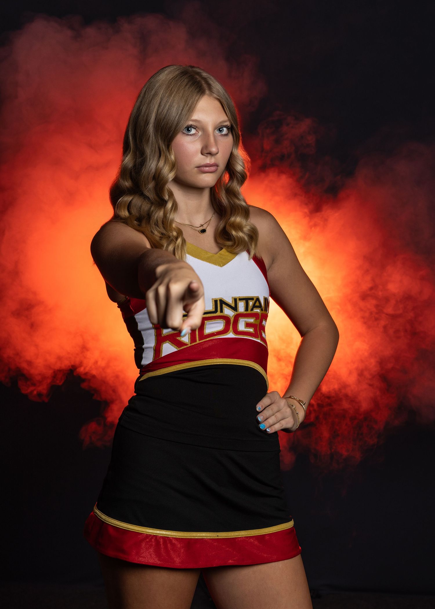 Athletic uniform photoshoot against dramatic red and black smoky background.