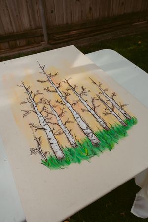 Step by step watercolor painting process showing birch trees and grass being added to create a forest scene.
