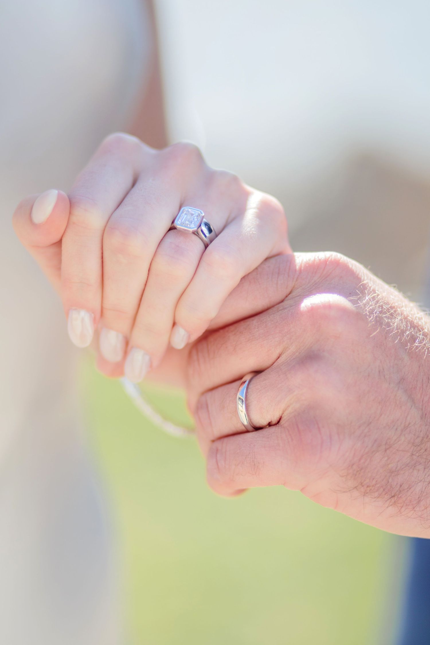 Close-up of newly wed bride and groom's hands.