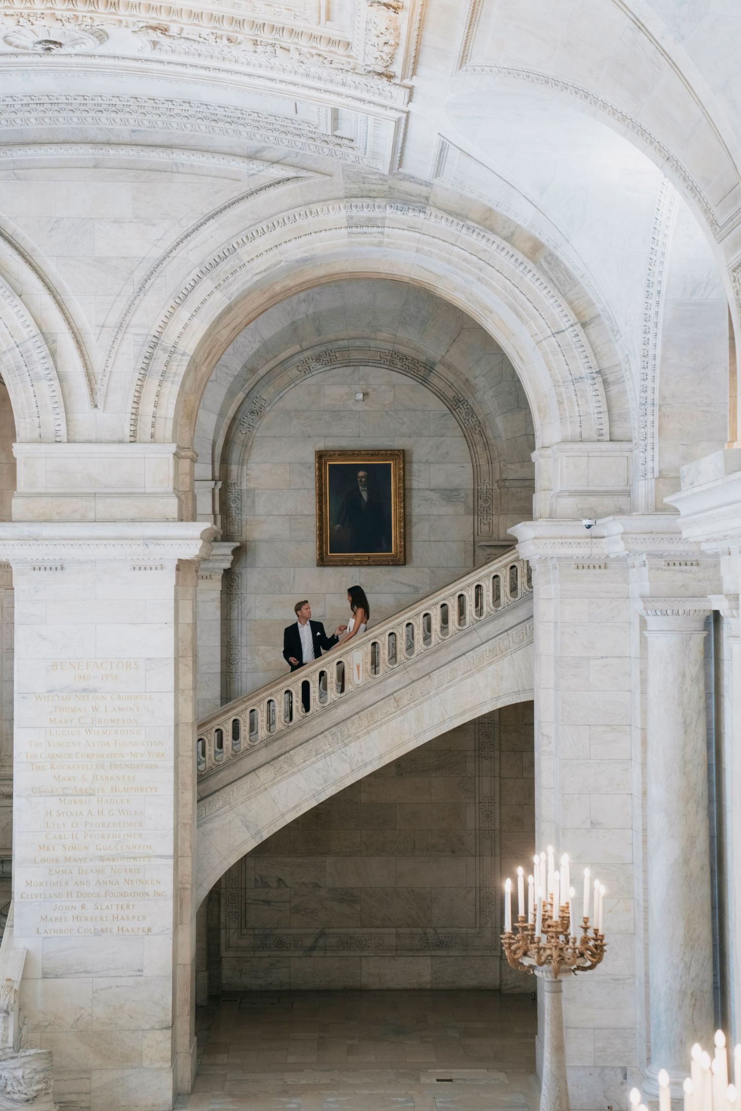 Elegant white marble archways and grand staircases in a classic architectural interior.