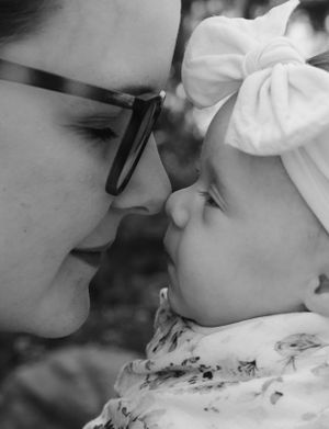 A tender moment captured in black and white with a white bow accessory.