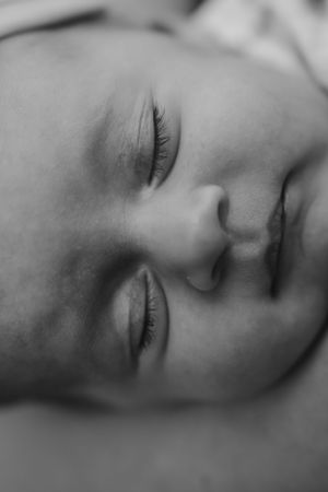 Close up of peaceful sleeping infant in black and white.