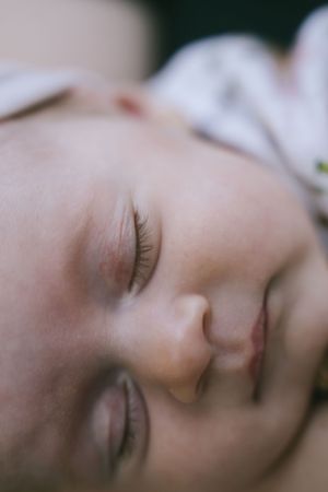 Serene close-up portrait of sleeping baby in soft focus.