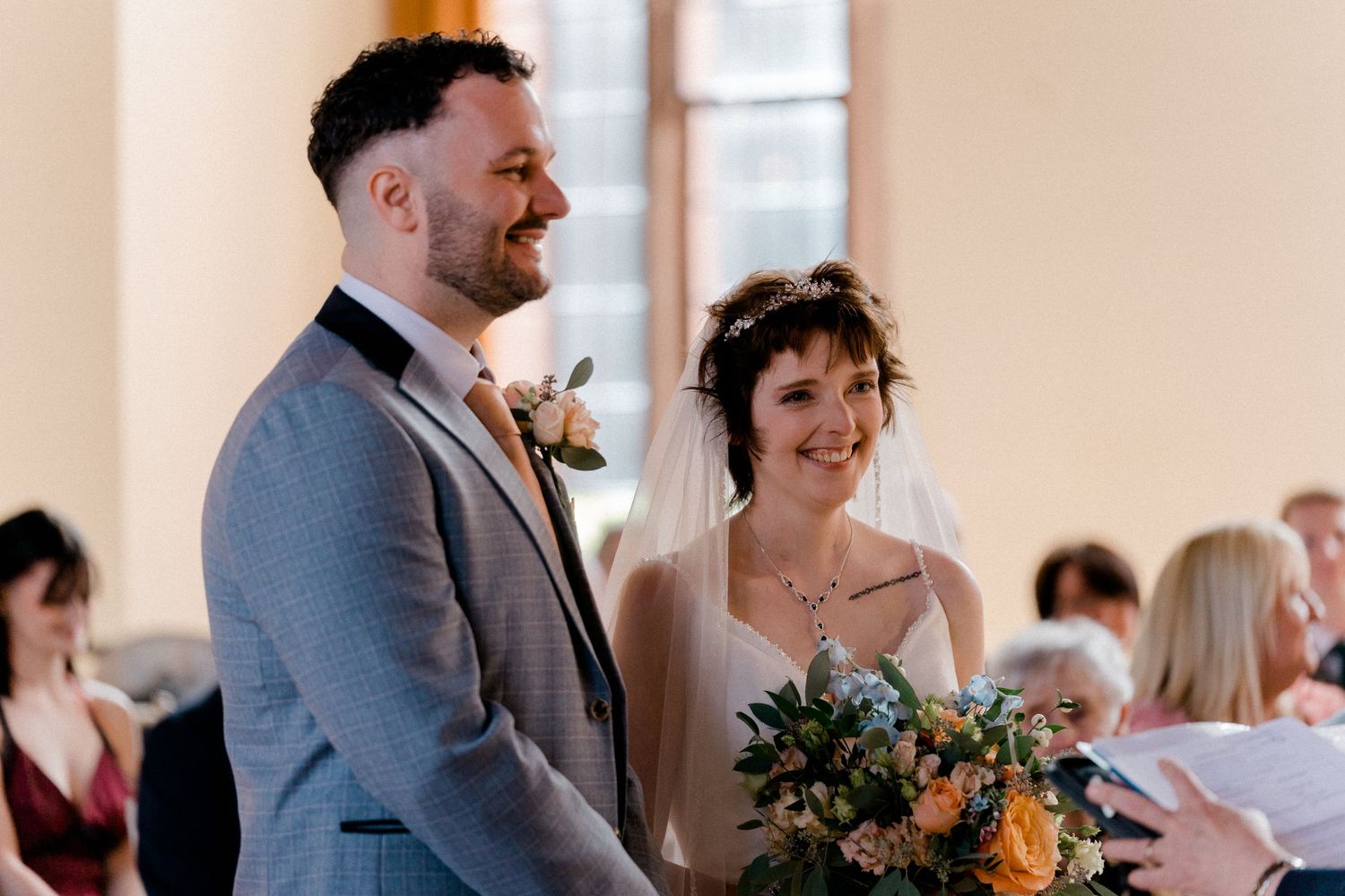 Happy couple sharing a joyful moment during their wedding ceremony.
