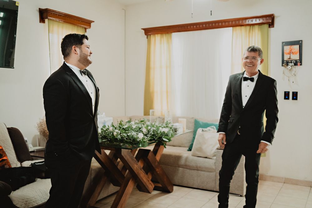 Father and brother sharing smiles, a joyful family moment before the wedding