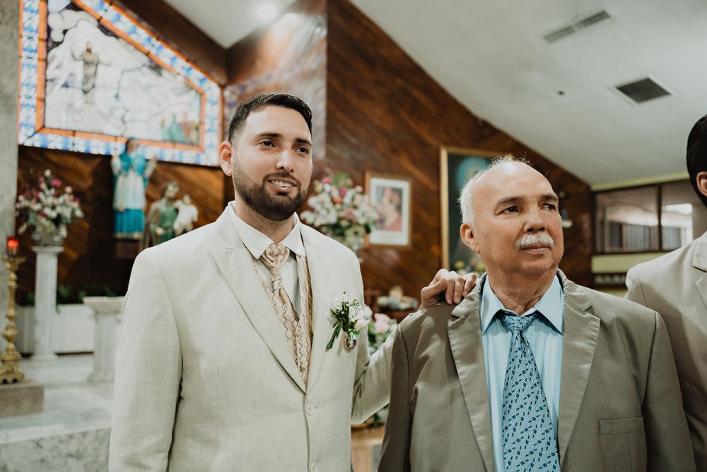 The groom and his father watching the bride walk down the aisle, an emotional scene