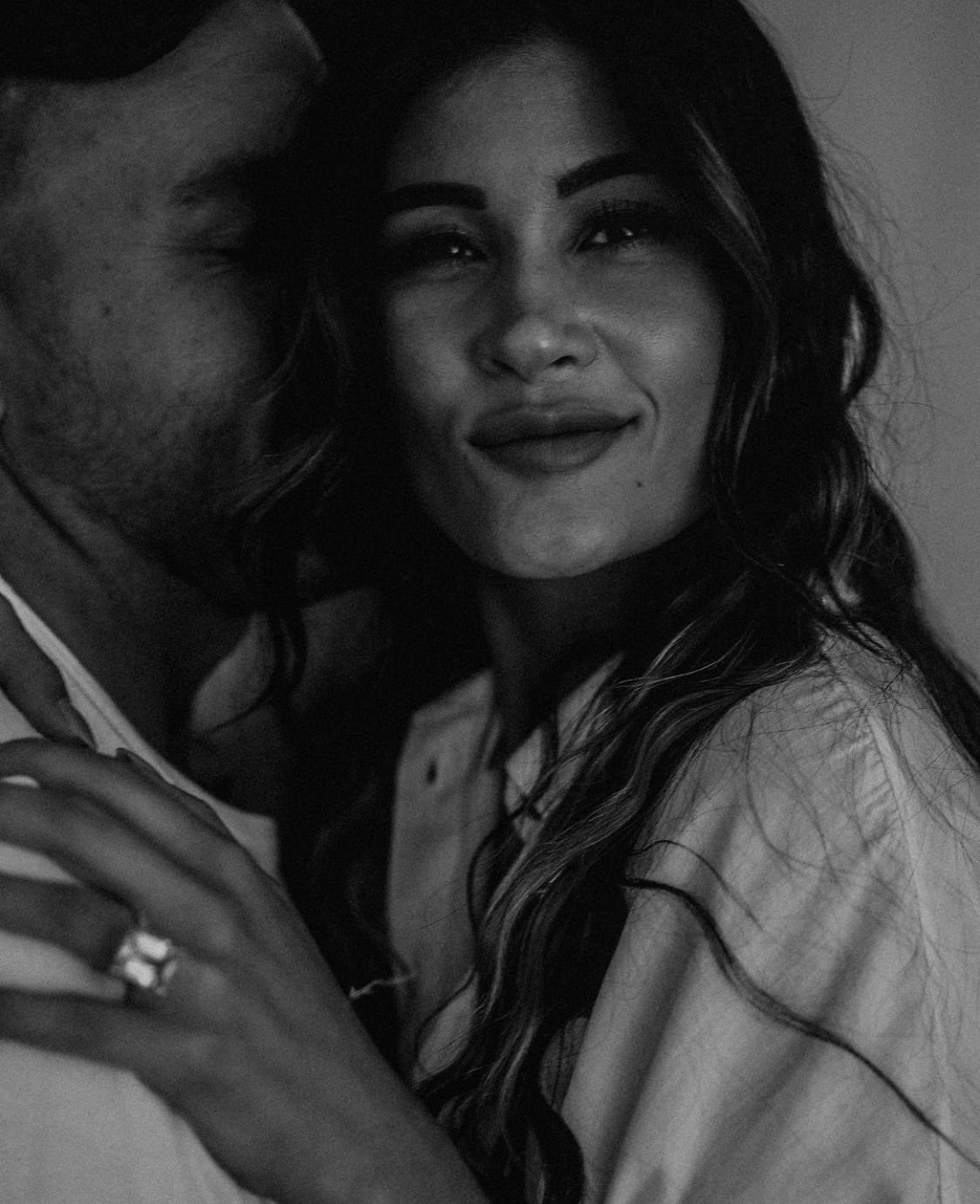 A romantic black and white portrait of a couple sharing an intimate moment together.
