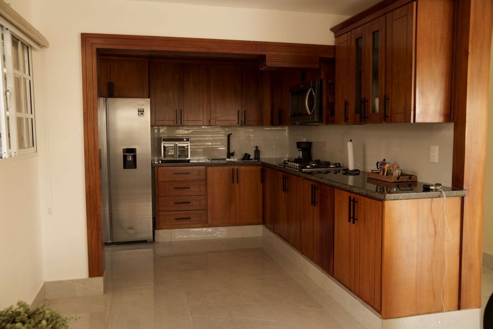Expansive kitchen featuring wood cabinetry, stainless appliances and open layout design.