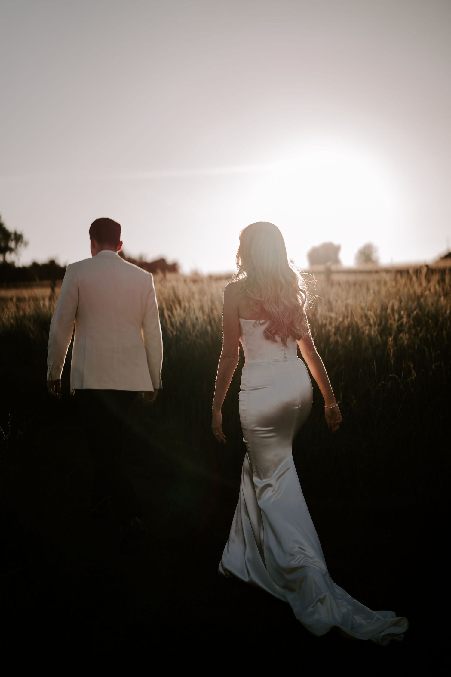 bride and groom walking into the sunset at hamswell house wedding in bath