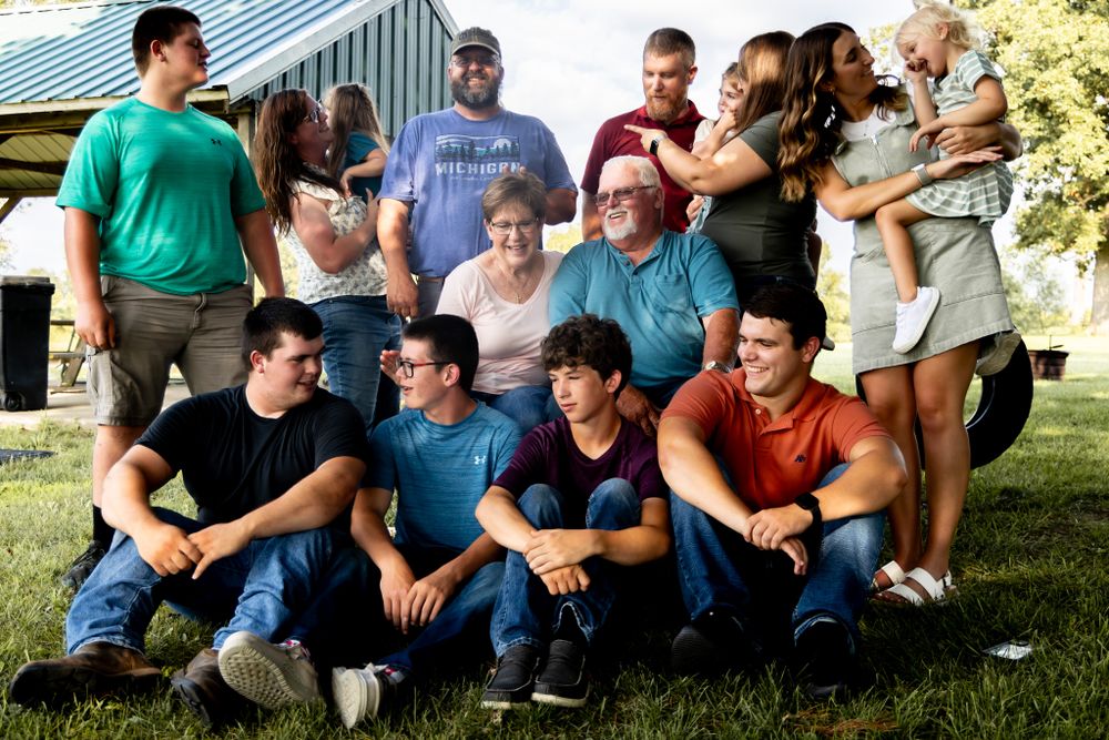 Casual group photo of friends and family gathered outdoors in summer.