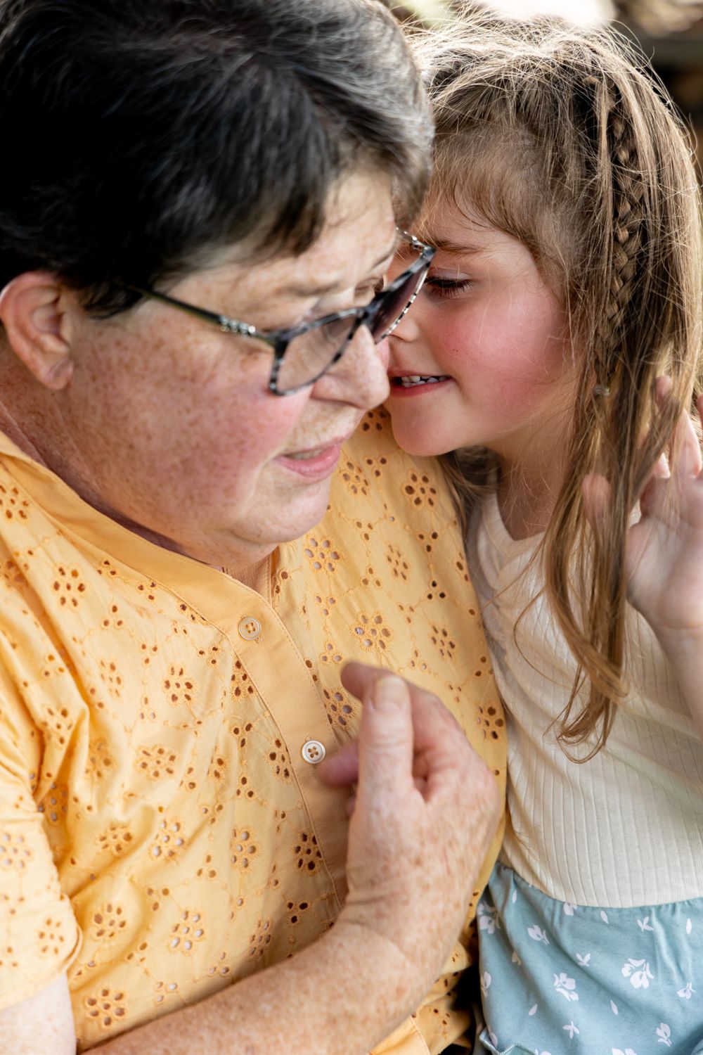 An intimate moment captured between two generations sharing a close embrace.